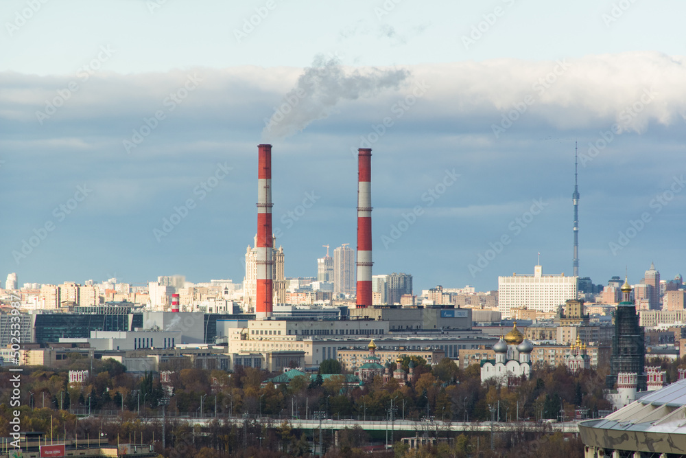 factory pipes on background of city