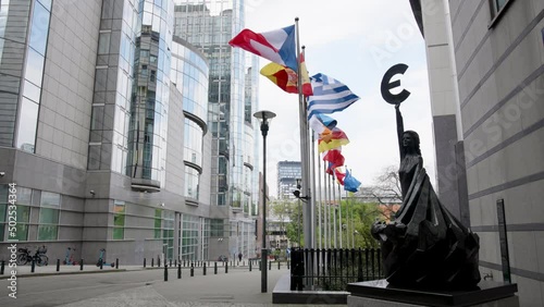 European flags billow along the Belgian Paul Henri Spaak Building memorial, Parliament, slow motion photo