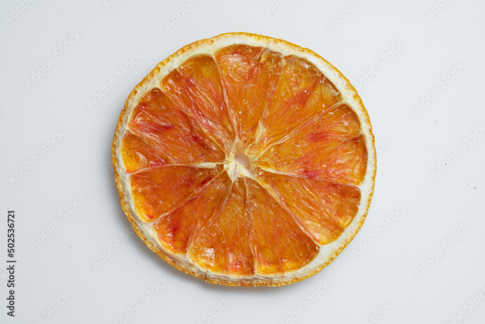 Close up of Natural Dried Oranges Slices Snack. Dried Oranges for baking. Dried grapefruit, slices and dried candie citrus fruit. Isolated white background. Close up of Natural Dried Oranges Slices Snack. Dried Oranges for baking. Dried grapefruit, slices and dried candie citrus fruit. Isolated white background.