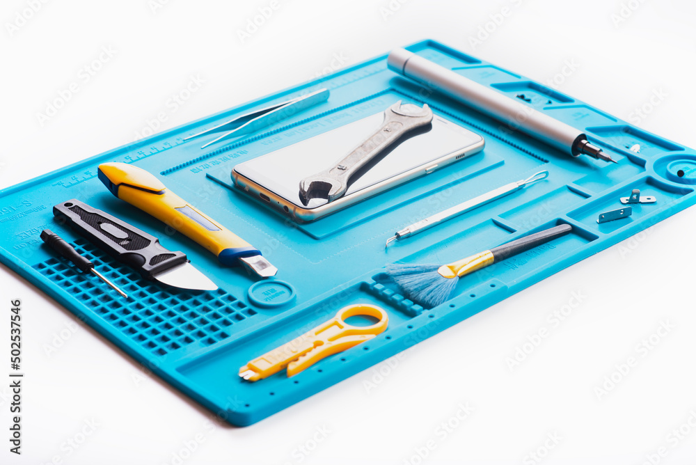 Flat lay image of dismantling the broken smart phone for preparing to repair or replace some components, Top view