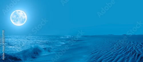 Fototapeta Naklejka Na Ścianę i Meble -  Namib desert with Atlantic ocean meets near Skeleton coast with full moon at night - 
Namibia, South Africa 