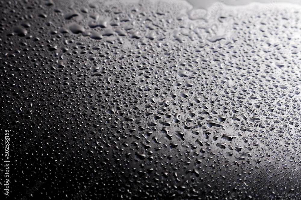 Dark shiny surface with droplets. Close up image of wet shiny background. Dark shiny surface with droplets. Close up image of wet shiny background.