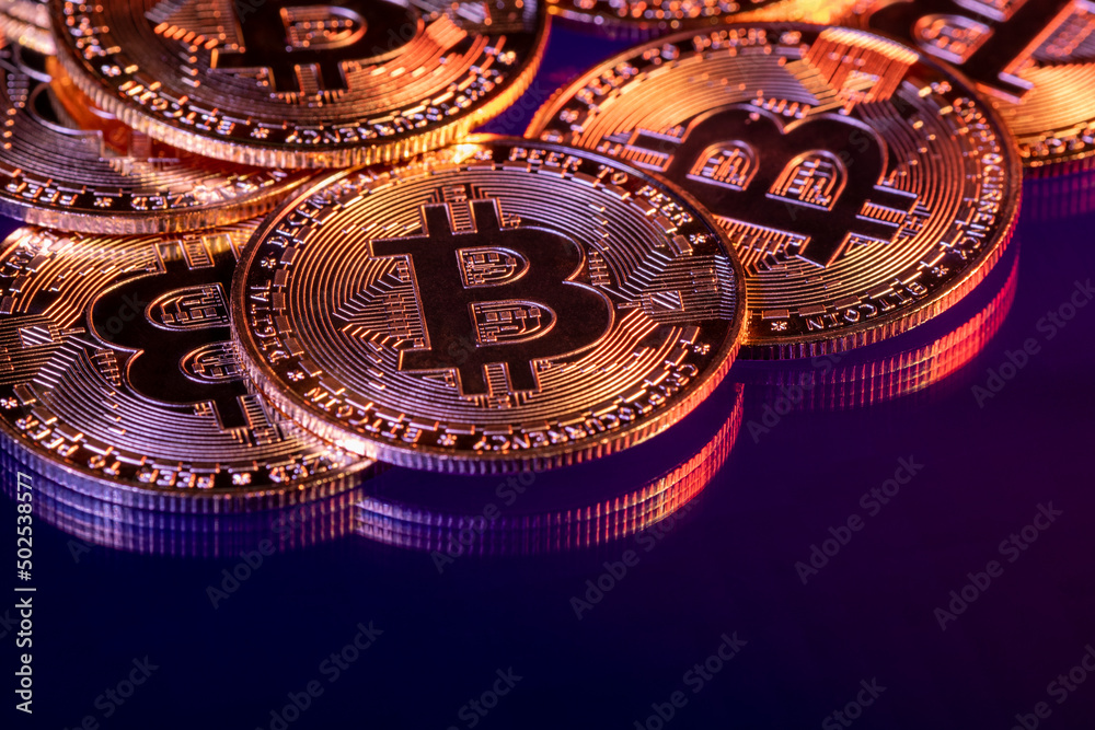 Close up photo of gold plated bitcoins symbolizing the bit coin market and modern technology, finance, internet, trading.