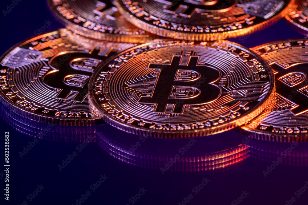 Close up photo of gold plated bitcoins symbolizing the bit coin market and modern technology, finance, internet, trading.