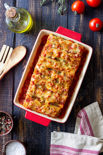 Cannelloni with meat, cheese, tomatoes and thyme. Italian cuisine.