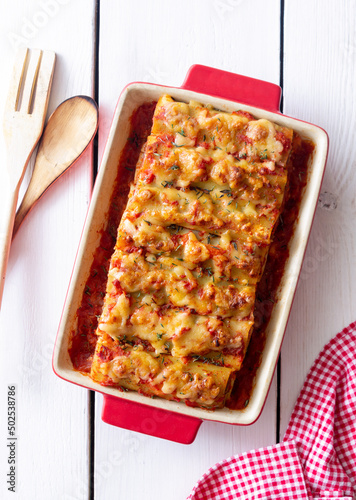 Cannelloni with meat, cheese, tomatoes and thyme. Italian cuisine.