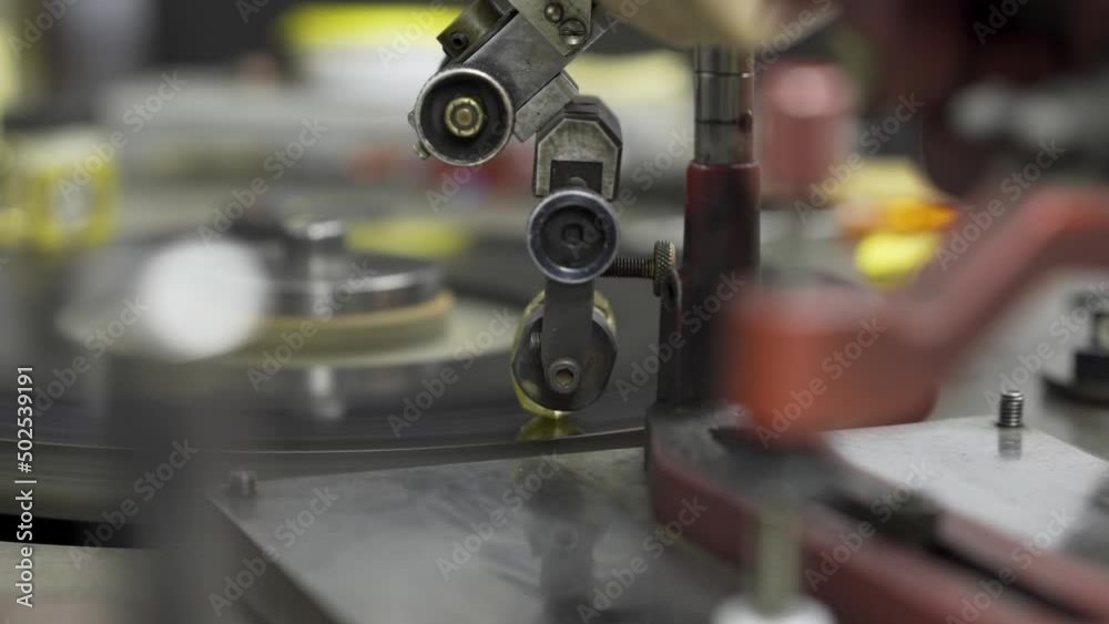 A large carat rough diamond is cut and shaped on a spinning grinding disk in the workshop of a skilled diamond cutter. A large carat rough diamond is cut and shaped on a spinning grinding disk in the workshop of a skilled diamond cutter.