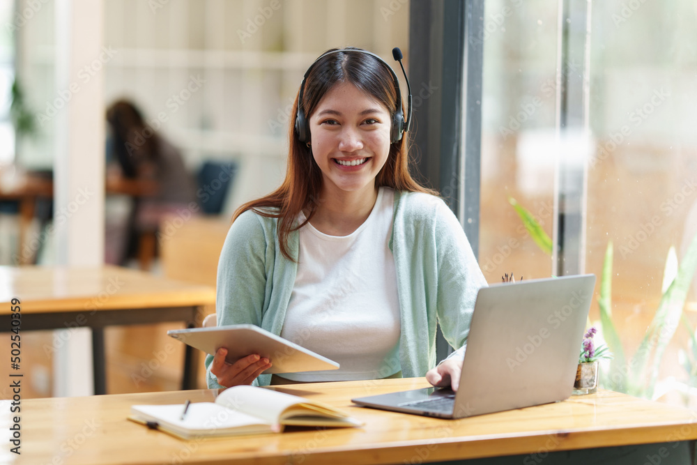 E-learning Online Education concept. Asian woman attentive student student video conference e-learning with teacher on laptop computer at home. E-learning Online Education concept. Asian woman attentive student student video conference e-learning with teacher on laptop computer at home.