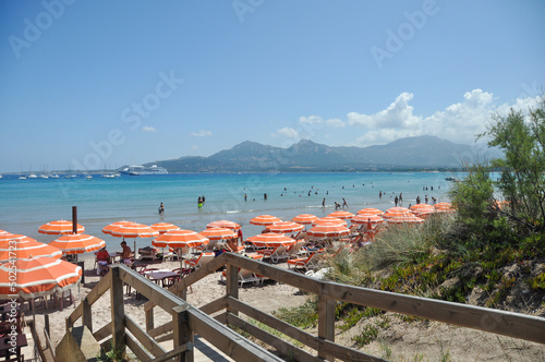 View of the bay of Calvi, Corsica, France. Orange striped umbrellas.