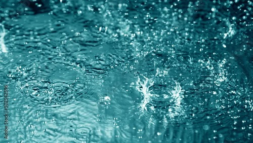 Super Slow Motion Shot of Many Water Drops Falling and Splashing on Surface at 1000fps. photo