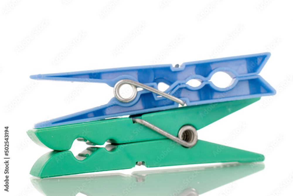 Two plastic clothespins, macro, isolated on a white background. Two plastic clothespins, macro, isolated on a white background.