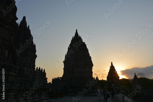 The ruins of the ancient Hindu temple of Prambanan at sunset with very interesting sky in the background and the temple stupas in the foreground