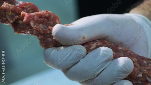 Chef making shish kebab on the skewer. slow motion,close up. 4K