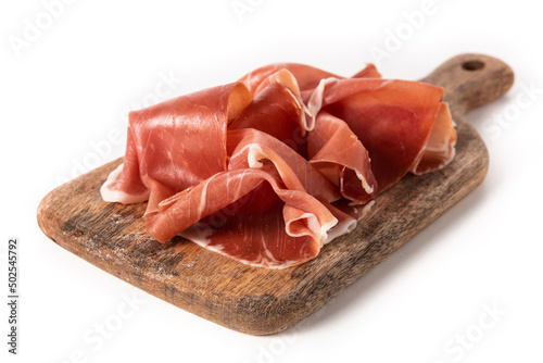 Spanish serrano ham on cutting board isolated on white background photo