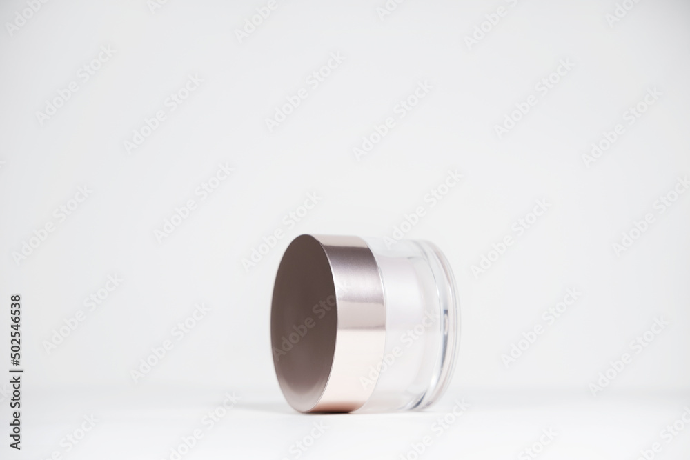 A mock up jar of cream isolated on a white gray background, on a white table with hard shadows. Stylish look of the product, identity. A mock up jar of cream isolated on a white gray background, on a white table with hard shadows. Stylish look of the product, identity.