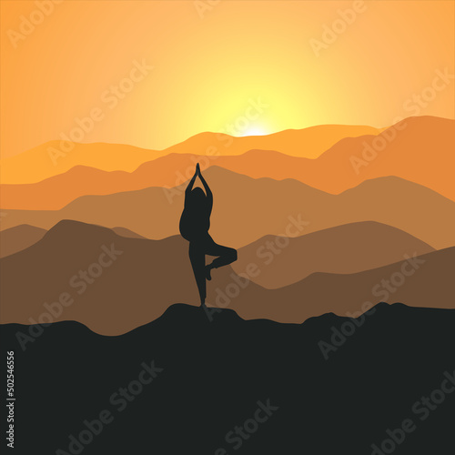 silhouette of a person standing on a mountain