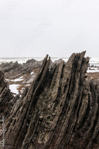 stratified rocks on the beach of sopelana in the basque country