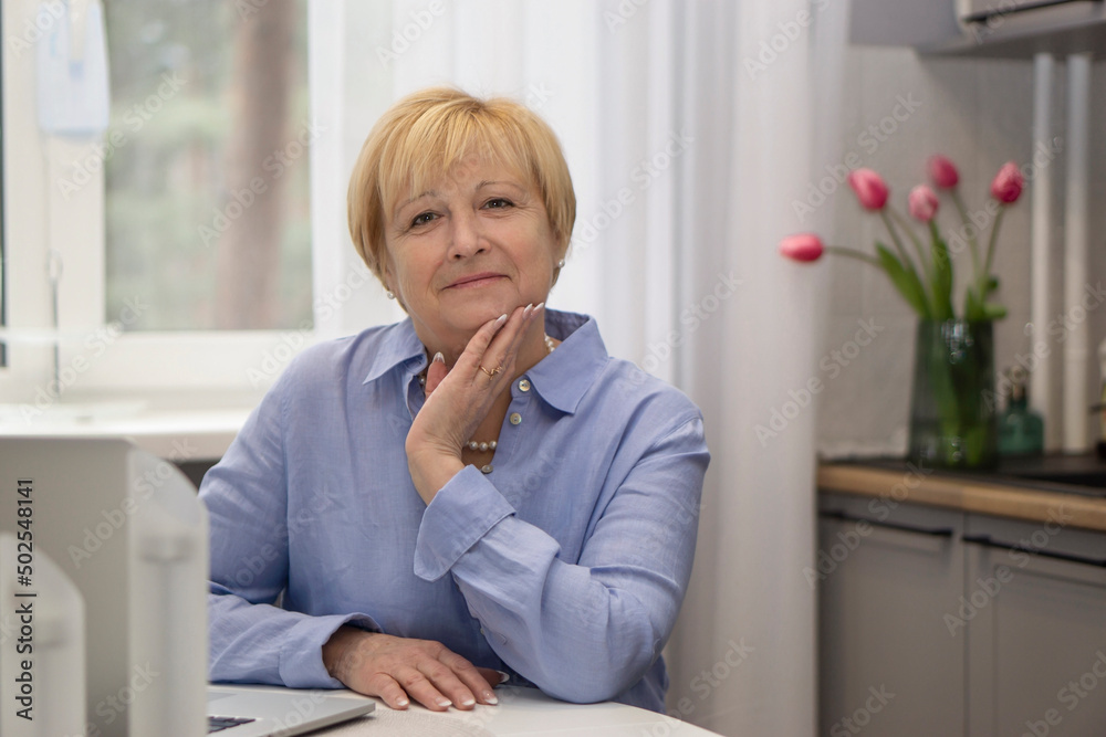 Portrait Older woman working on laptop ta home. Portrait Older woman working on laptop ta home.