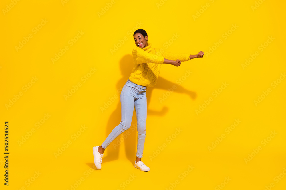 Full length body size view of attractive cheerful thin dreamy girl dancing good day isolated over bright yellow color background