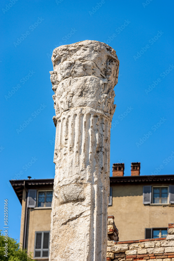 Closeup of an old white column of the ancient ruins of the Capitolium Roman Temple (Tempio Capitolino) in Brescia downtown, 73 AC, UNESCO world heritage site, Lombardy, Italy, Europe.