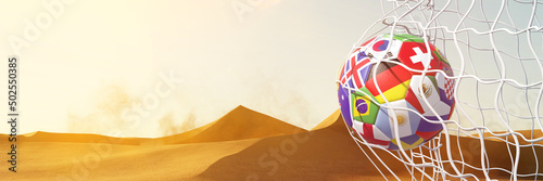 Vászonkép Fußball mit Länder Flaggen im Tor vor Wüste von Katar