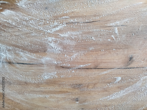 White flour on wooden table. Free space for text. View from above. Top view