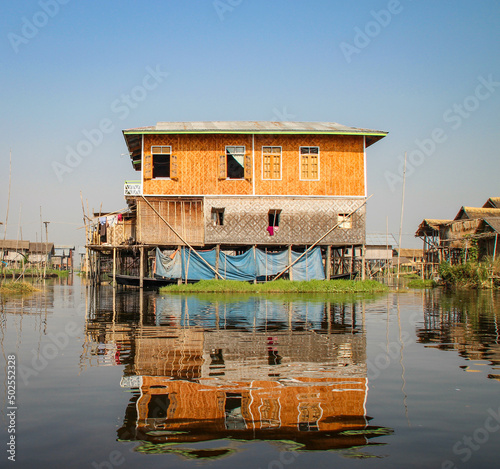Reflection of wooden stilted houses at Inle Lake Burma