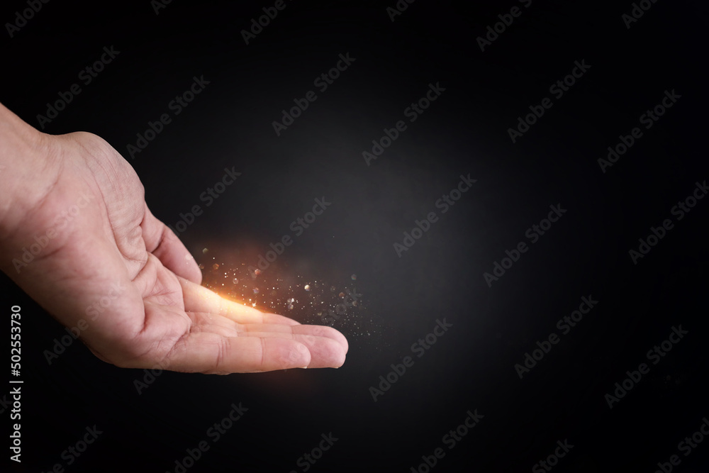 Human hand and magical glowing light Human hand and magical glowing light