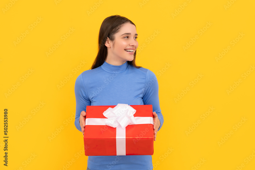 seasonal sales. smiling girl with box on yellow background. boxing day. present and gifts buy seasonal sales. smiling girl with box on yellow background. boxing day. present and gifts buy