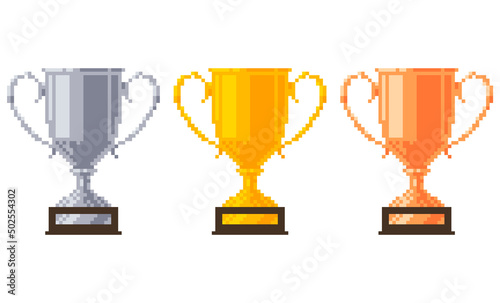 Pixel trophy cups on a wooden stand with name plates. Golden, silver and bronze goblets. Vector illustration.