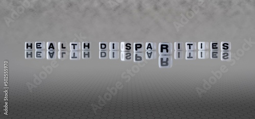 health disparities word or concept represented by black and white letter cubes on a grey horizon background stretching to infinity photo