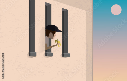 Young man in window eating banana