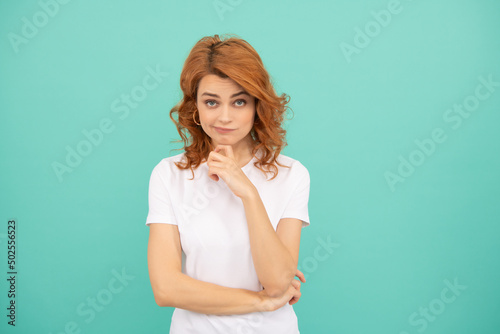 making decision redhead woman with curly hair on blue background