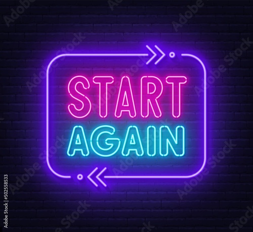 Start again neon sign on a brick background.