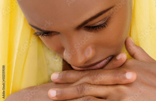 Close-up portrait of a moody teenage girl wearing a yellow veil, eighteen years old, perfect golden skin, natural ambiant light	 photo