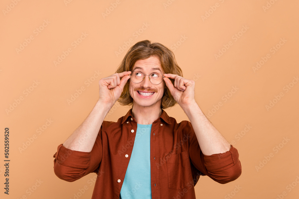 Portrait of attractive curious red-haired guy overthinking copy blank space isolated over beige pastel color background Portrait of attractive curious red-haired guy overthinking copy blank space isolated over beige pastel color background