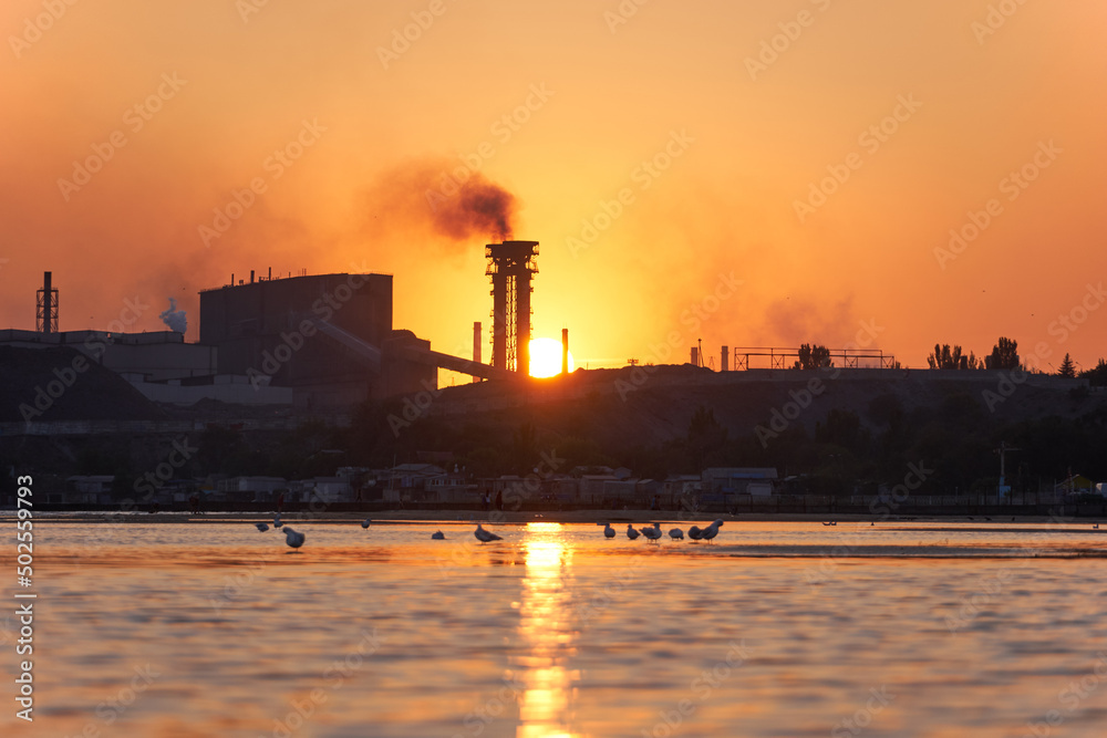 Sea sunset over the industrial zone of Azovstal plant