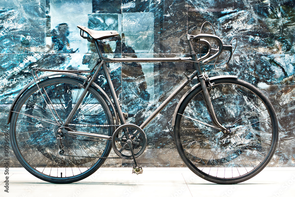 Black bicycle near marble wall