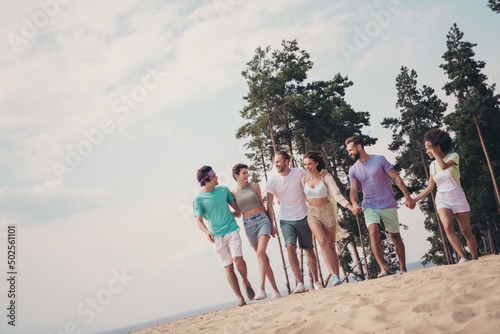 Photo of six inspired relaxed friends group people hold hands hug walk wear casual outfit nature summer seaside beach