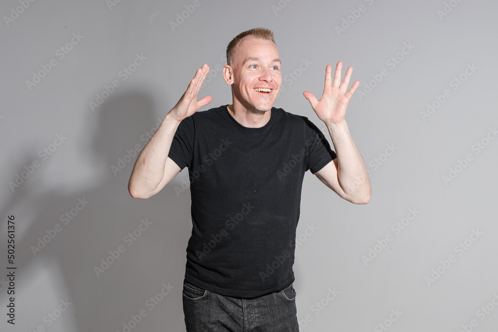 happy man keeping his hands up and smiles happy man keeping his hands up and smiles