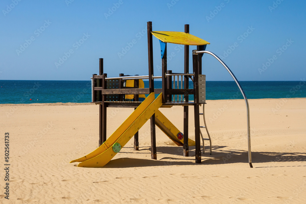 Structure with slides for children's games on the beach, facing the sea Structure with slides for children's games on the beach, facing the sea