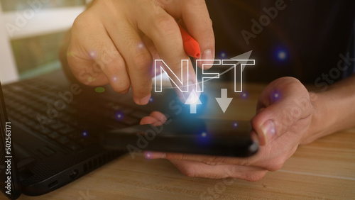 NFT irreplaceable online data transmission concept. Businessman touches NFT holograms. Unique art on digital binary background. © thanakon