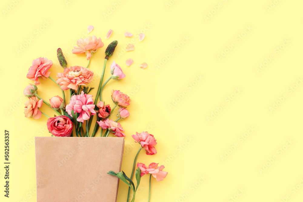 Top view image of pink flowers composition over yellow background Top view image of pink flowers composition over yellow background