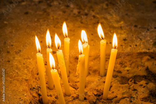 Image of many burning candles.