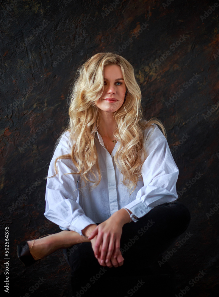 Fototapeta premium Authentic natural portrait of beautiful and gorgeous business woman in white shirt in studio in vintage retro style