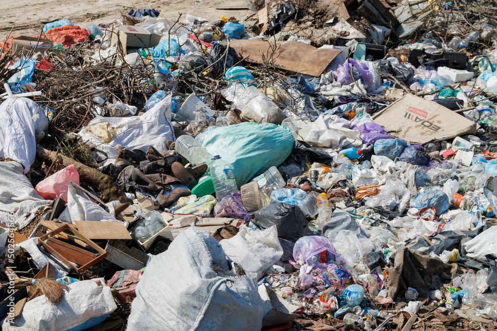 A view of the landfill. Garbage dump. A pile of plastic rubbish, food waste and other rubbish. Pollution concept. A sea of garbage starts to invade and destroy a beautiful countryside scenery A view of the landfill. Garbage dump. A pile of plastic rubbish, food waste and other rubbish. Pollution concept. A sea of garbage starts to invade and destroy a beautiful countryside scenery