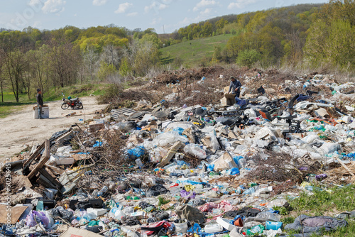 A view of the landfill. Garbage dump. A pile of plastic rubbish, food waste and other rubbish. Pollution concept. A sea of garbage starts to invade and destroy a beautiful countryside scenery