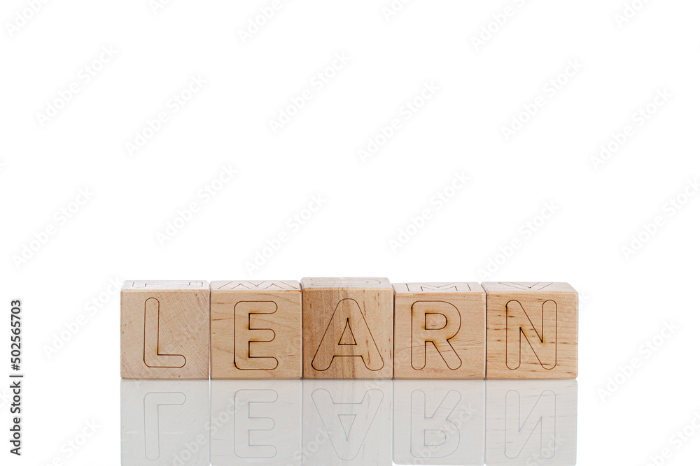 Wooden cubes with letters learn on a white background