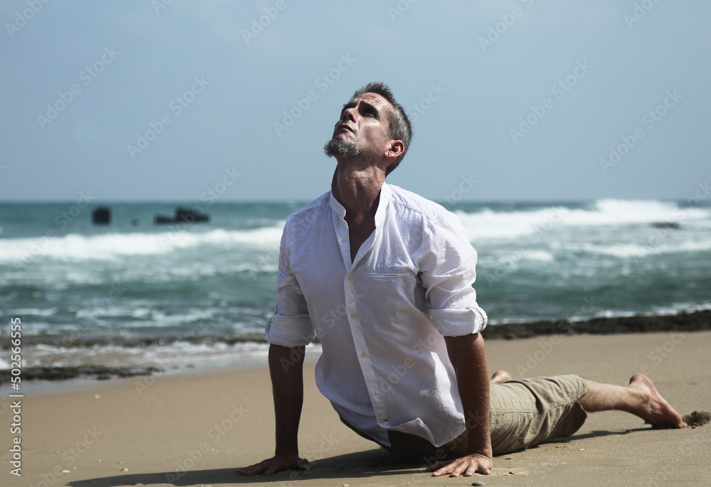 Yoga lesson. A man practices yoga near the sea. Yoga lesson. A man practices yoga near the sea.