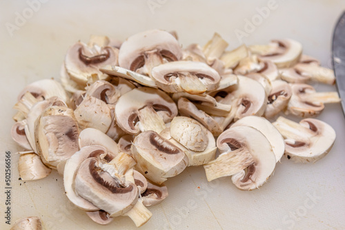 Cutting board with mushrooms on white background